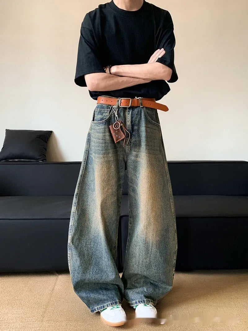 Men's retro blue distressed denim trousers with wide leg cut and vintage wash detailing