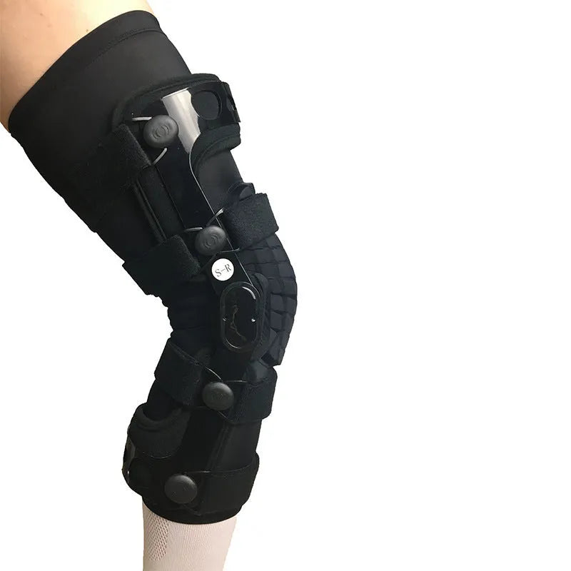 Black anterior cruciate ligament knee brace with visible metal side stays and hinges on a leg.