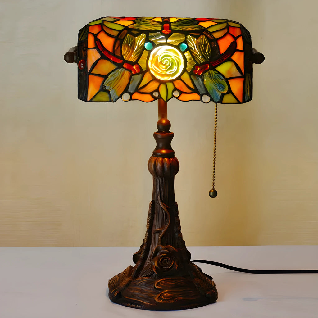 Tiffany table lamp with stained glass shade on resin base, 25cm wide by 36cm tall