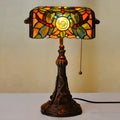 Tiffany table lamp with stained glass shade on resin base, 25cm wide by 36cm tall