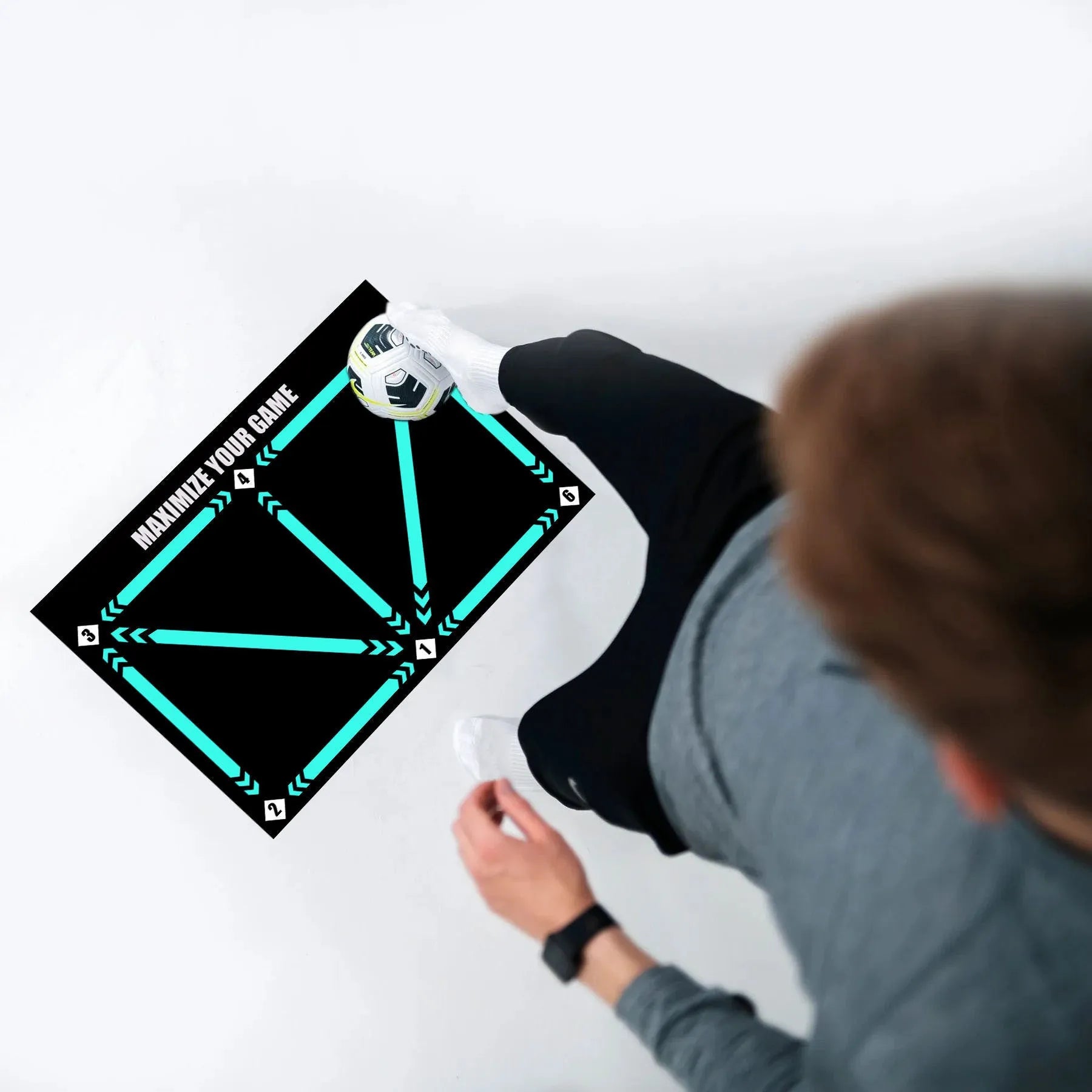 Black football training mat measuring 60x90cm on a flat surface
