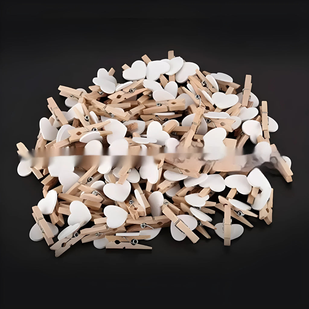 Five solid wood heart-shaped clips in red colour arranged together