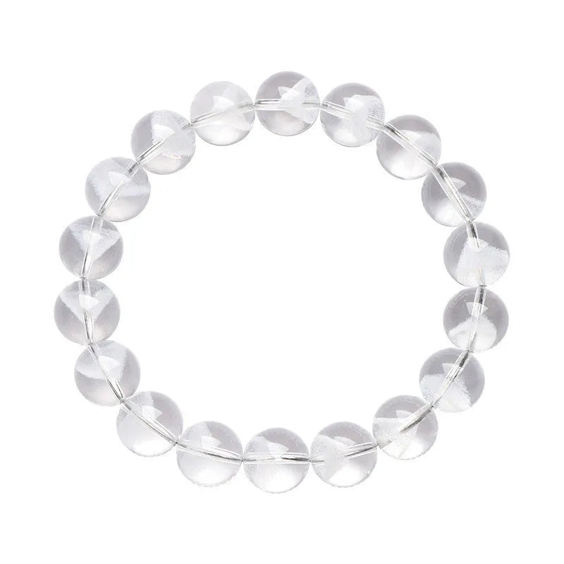 Close-up of a women's white crystal ghost pyramid bracelet with a Ruyi charm on a wrist.