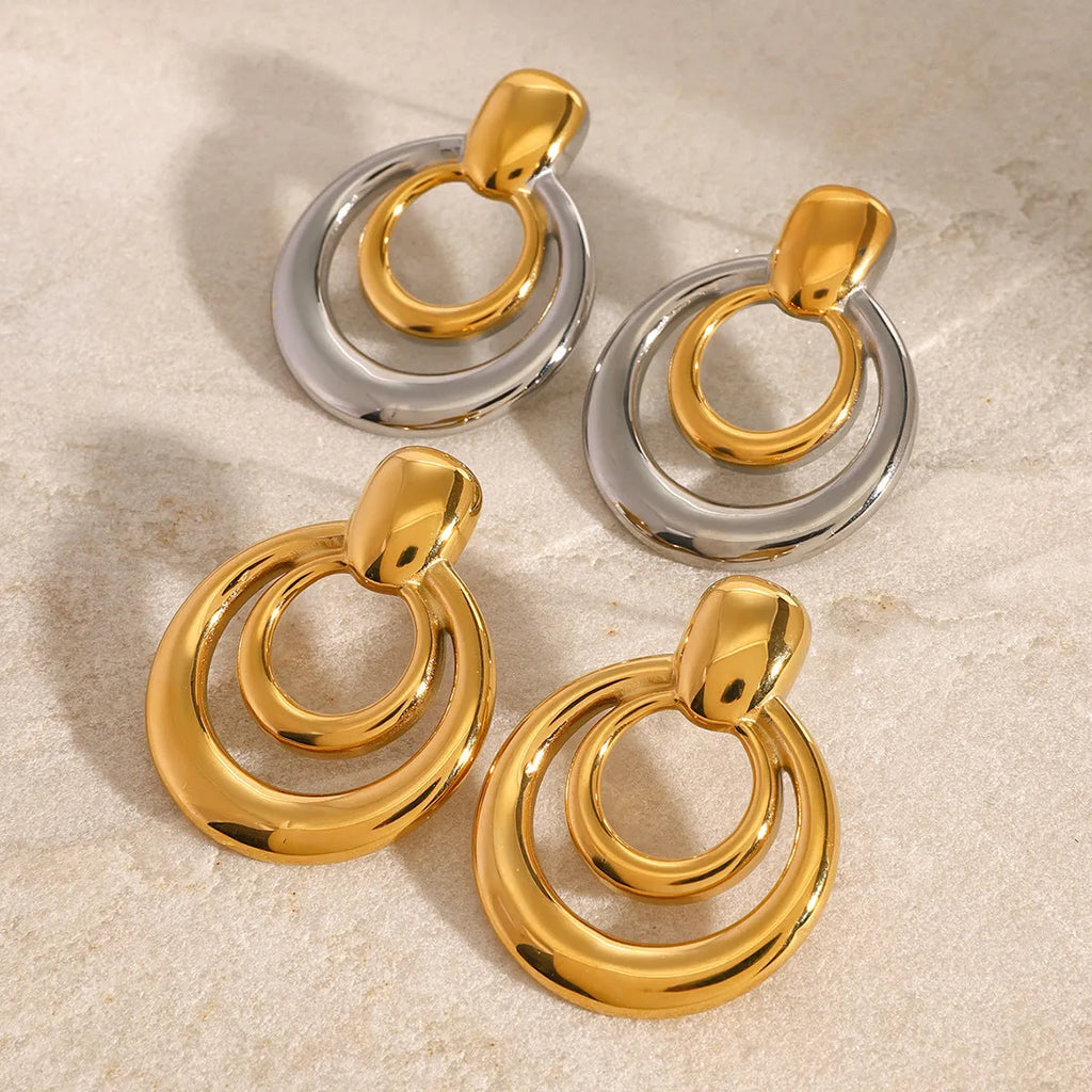 Round double layer hollow stud earrings with electroplated 18K gold finish in golden colour