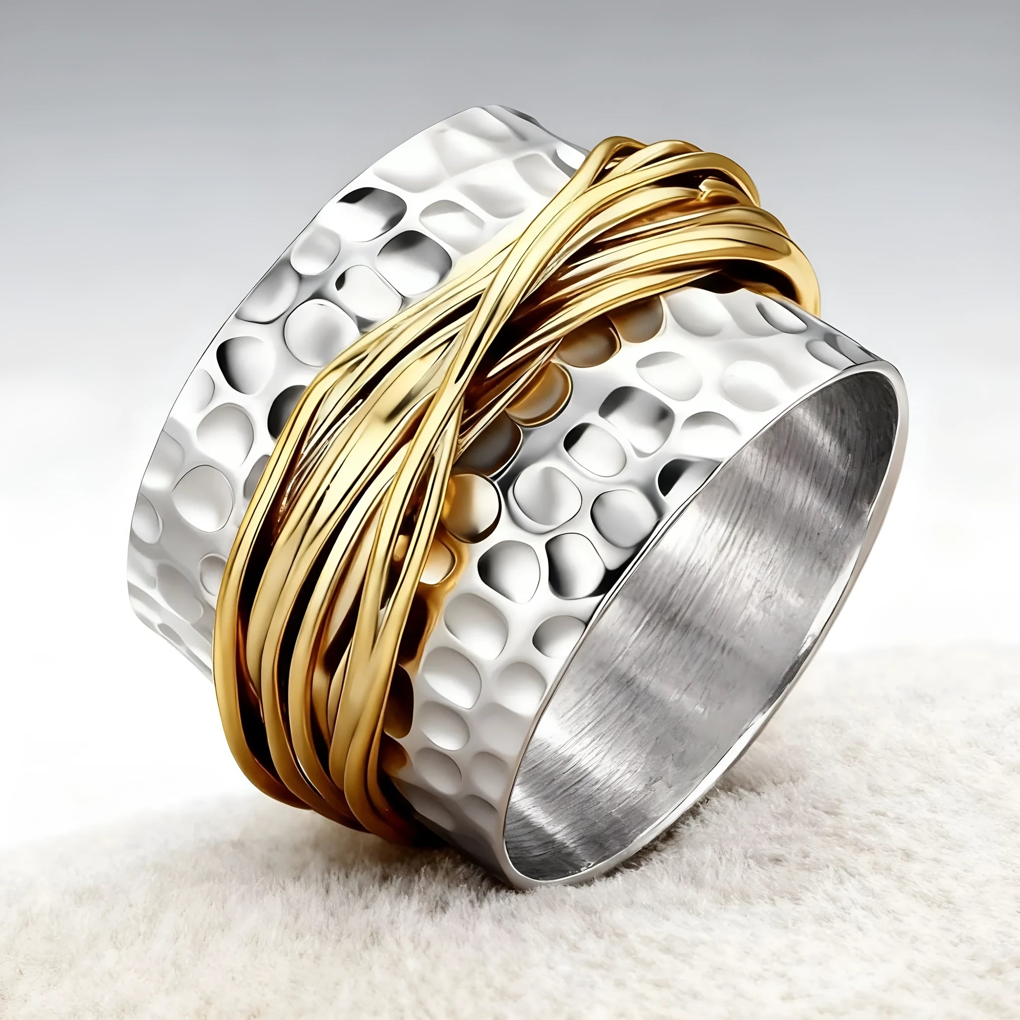 Alloy two-tone ring with hammered metal coil design, electroplated finish, on white background