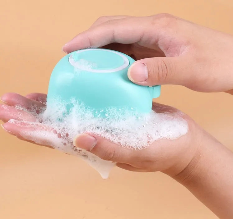 Silicone dog bath brush in blue, pink, and yellow colours, compact 9x6x8.5cm grooming tool
