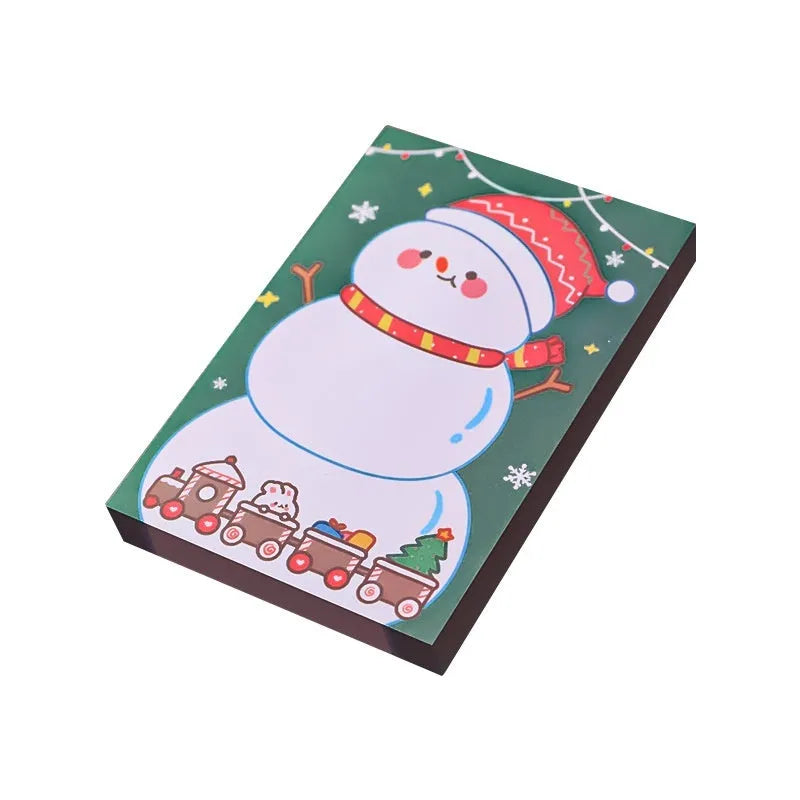 Christmas sticky notes book showing eight festive designs including elf, Santa, snowman, gift, house, bear, crystal ball, and sled