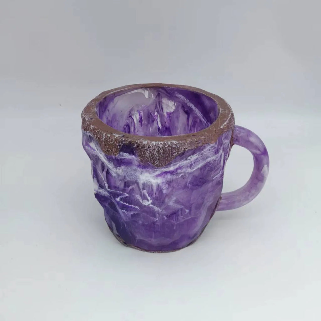 Purple resin coffee mug with 3D crystal texture and a handle on a wooden table.