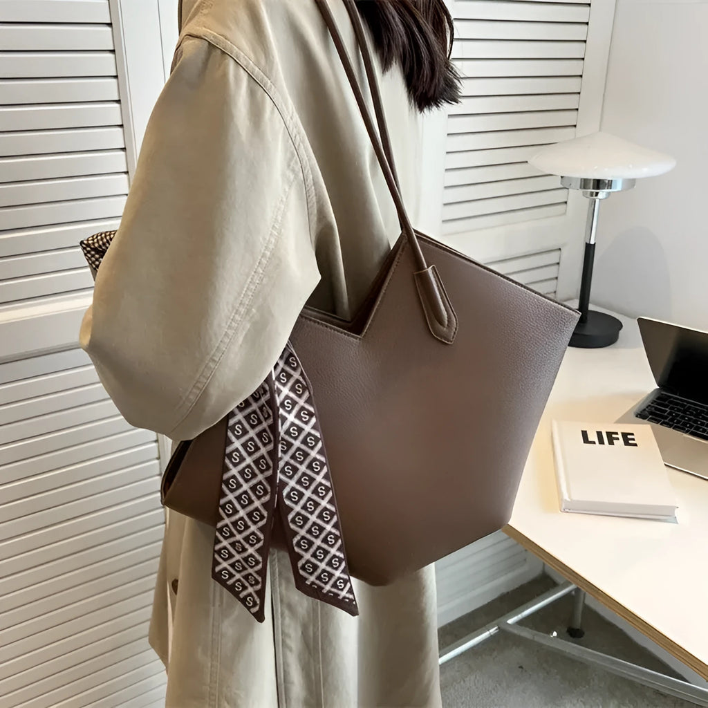 Women's large black PU leather shoulder bag with a sandwich pocket, shown next to a brown version.