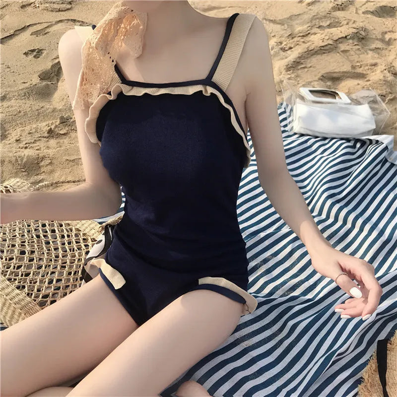 Conservative one-piece swimsuit for women in black with white edge, nylon fabric, size S to XL