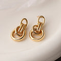 Gold-colour geometric copper earrings for women with an irregular, high-profile silhouette.