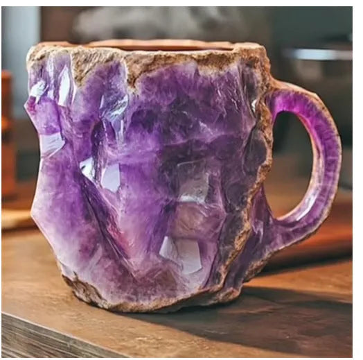Purple resin coffee mug with 3D crystal texture and a handle on a wooden table.