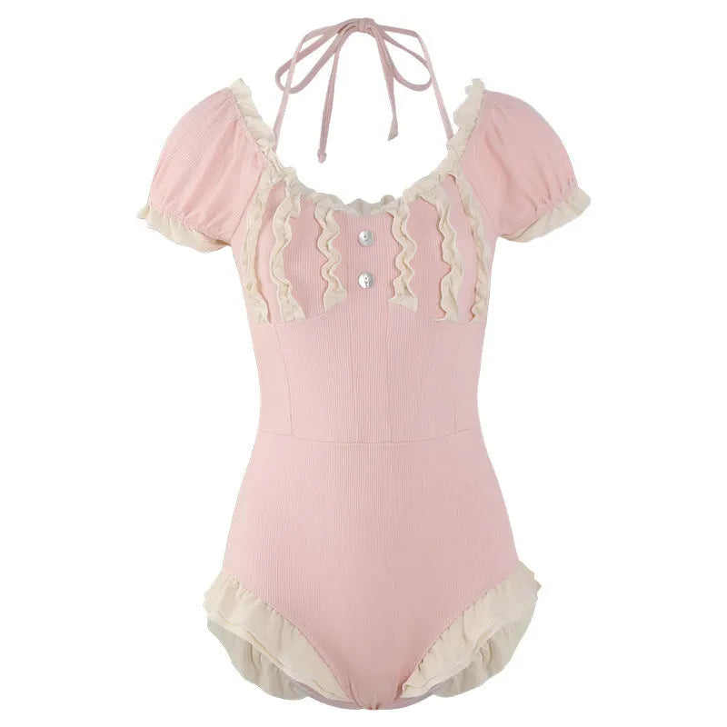 Pink women's conservative one-piece swimsuit with Siamese-style detailing on mannequin