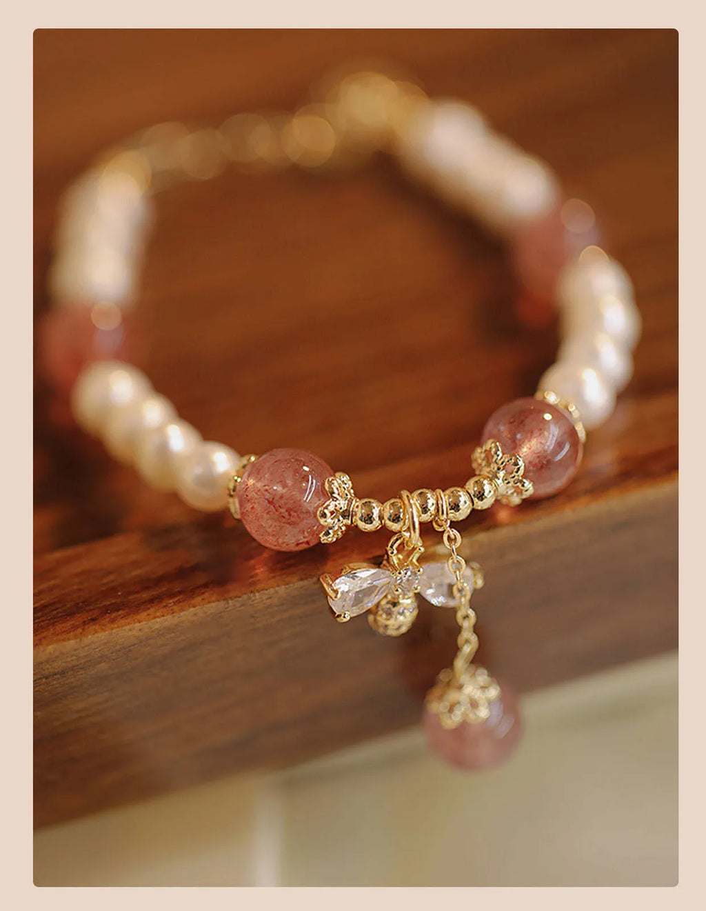 Close-up of a handmade crystal and strawberry quartz bracelet with a bow design, styled for women, INS aesthetic.