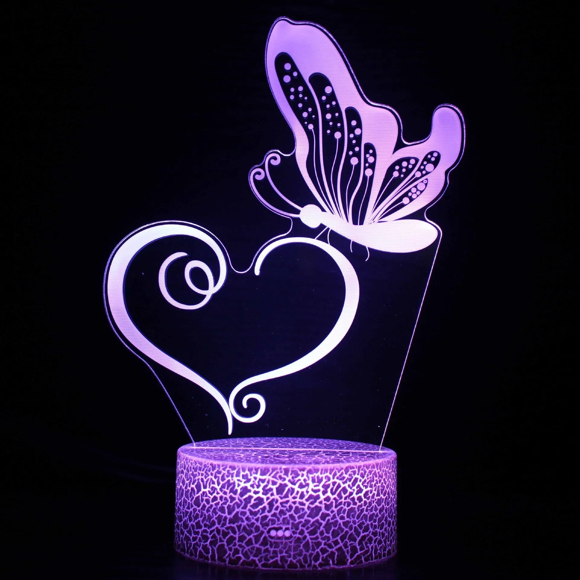 Small colourful acrylic 3D USB table lamp with touch control and crack base design on a desk.
