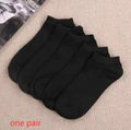 Black, white, and grey boat socks and medium tube socks from Degner in cotton blend fabric