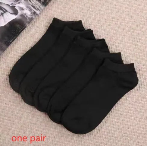 Black, white, and grey boat socks and medium tube socks from Degner in cotton blend fabric