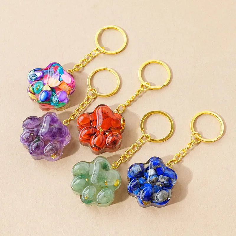 Natural crystal cat's paw keychain pendant in various gemstone colours including pink, red, green and blue variants