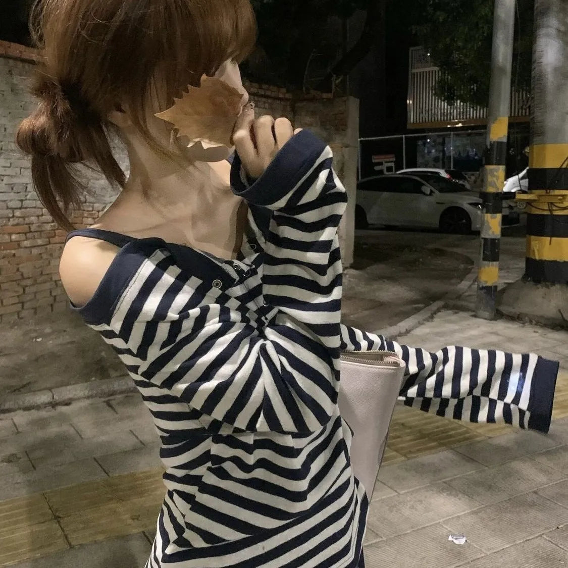 Dark blue women's oversized long-sleeve T-shirt with stripes, buttons, and embroidery details.