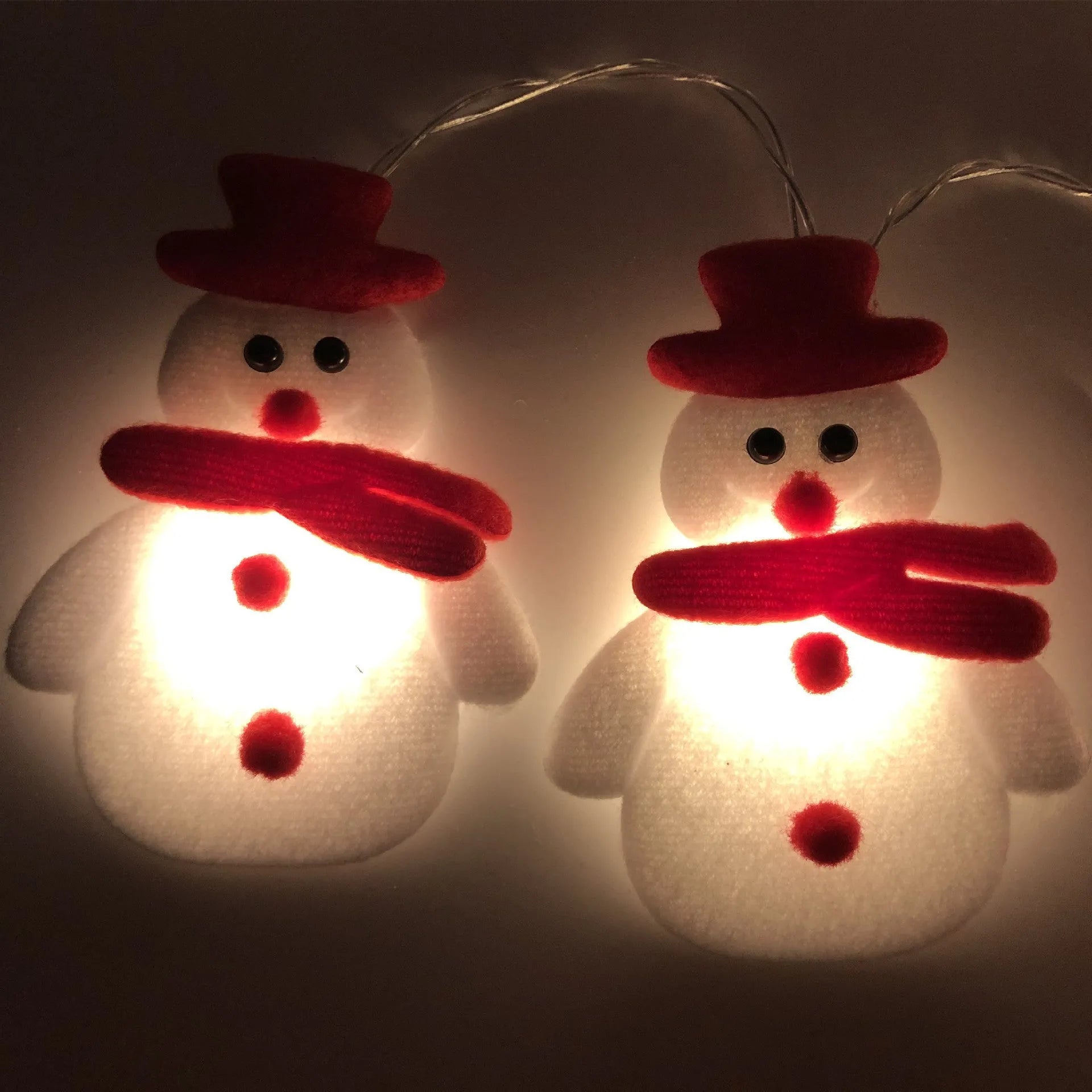 Christmas LED string lights with snowman figures, warm white glow, 1.65m length, battery powered, on a wooden mantelpiece