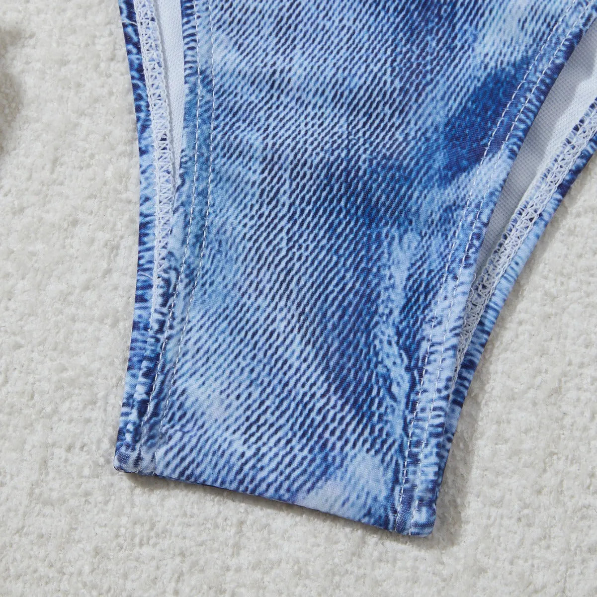 Denim blue printed women's bikini set with strappy triangle top and matching bottoms on a neutral background.