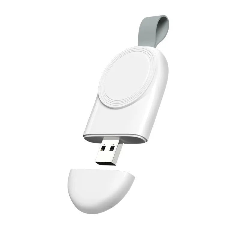 Portable Apple Watch wireless charging dock in white on a wooden table, with USB cable attached.