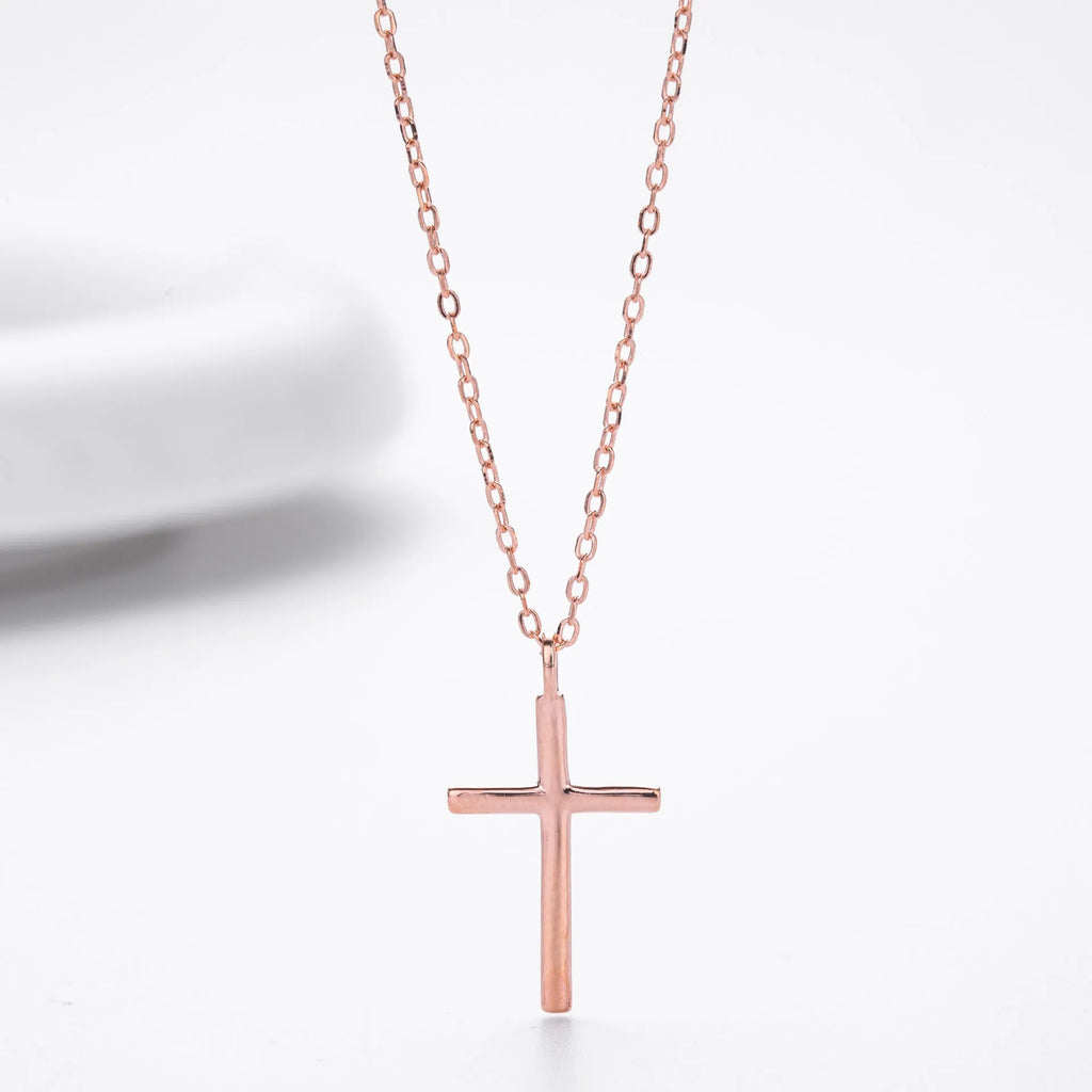 Simple glossy cross pendant on a sterling silver O-chain necklace.