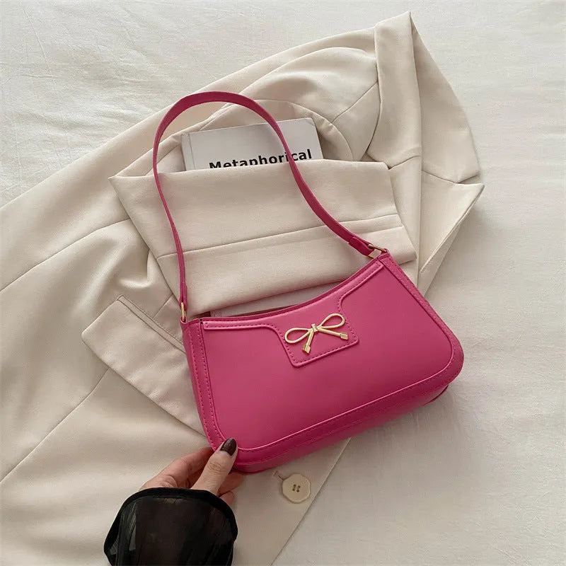 Portable PU shoulder bag in western baguette style with bow detail, 24x14x5 cm, available in multiple colours