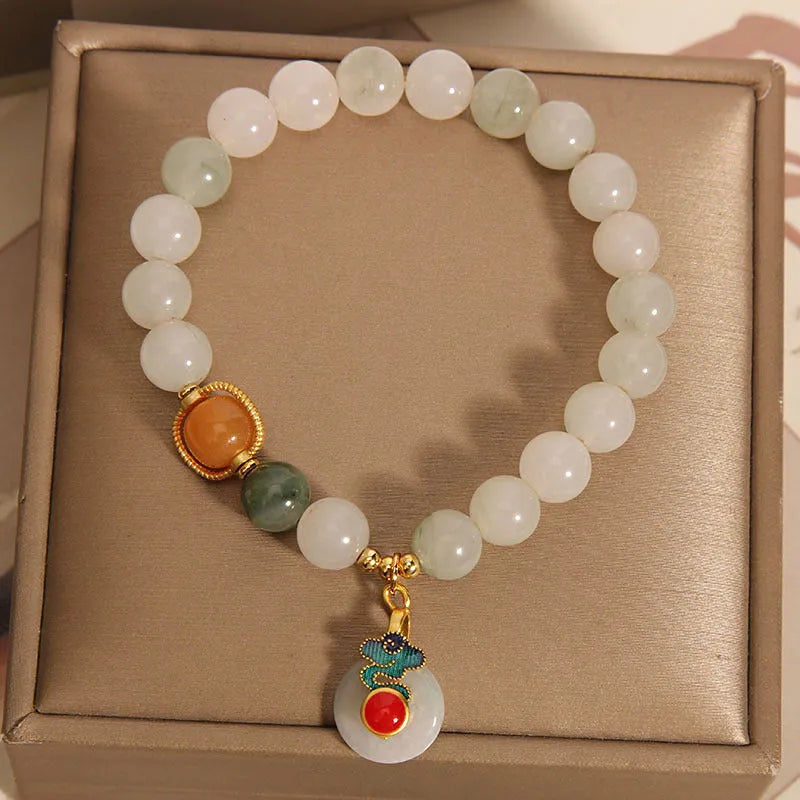 Ice jade colour women's bracelet with xiangyun buckle and pearl details.