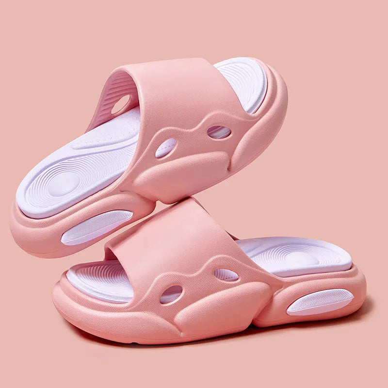Two-colour couple slippers showing thick EVA sole and round toe, displayed in black and white colourway.