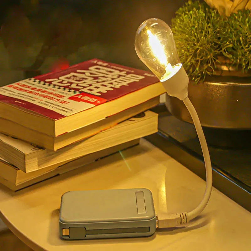 Folding USB rechargeable night light with tungsten filament bulb in warm white illumination