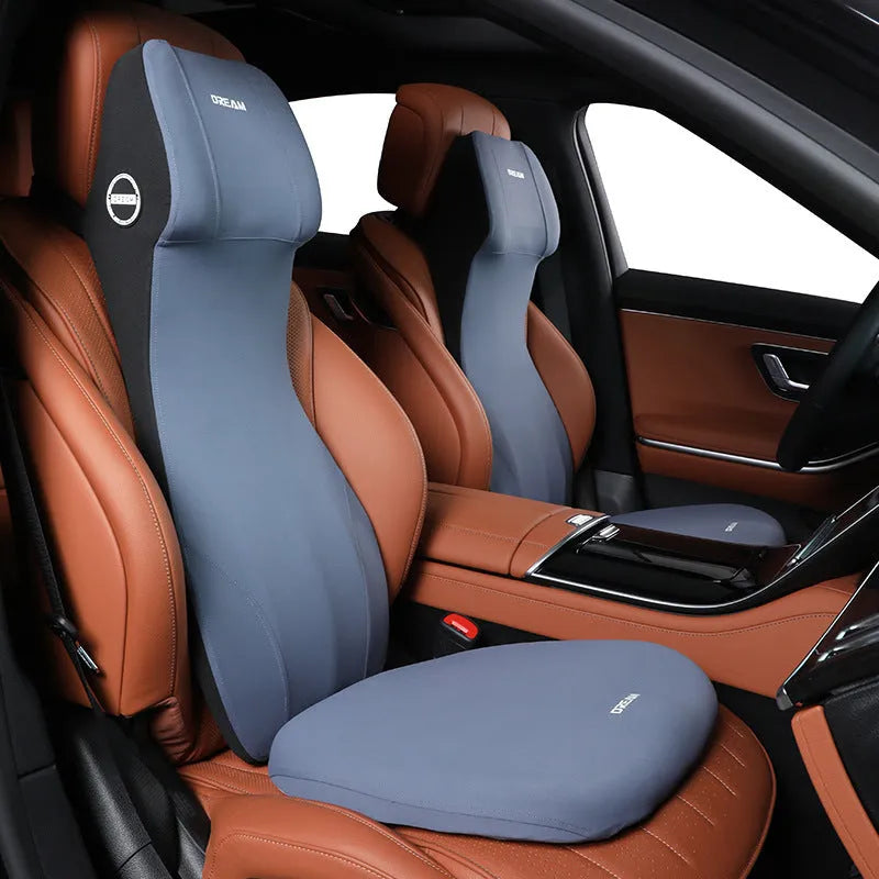 Black memory foam automotive waist cushion and headrest lumbar support pillow set on a car seat.