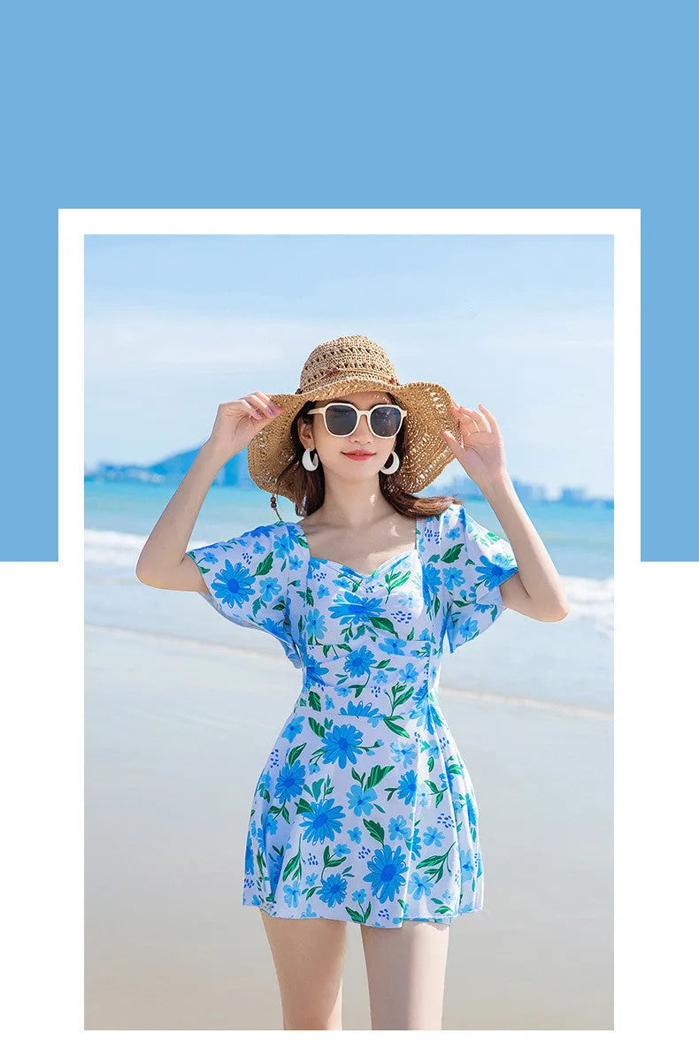 Women's one-piece slimming dress-style swimsuit with blue floral printed pattern on polyester fibre fabric