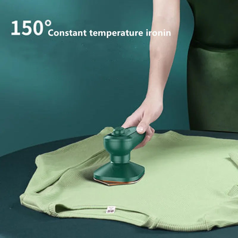 Dark green portable handheld hanging steam ironing machine with ceramic panel on a white background.