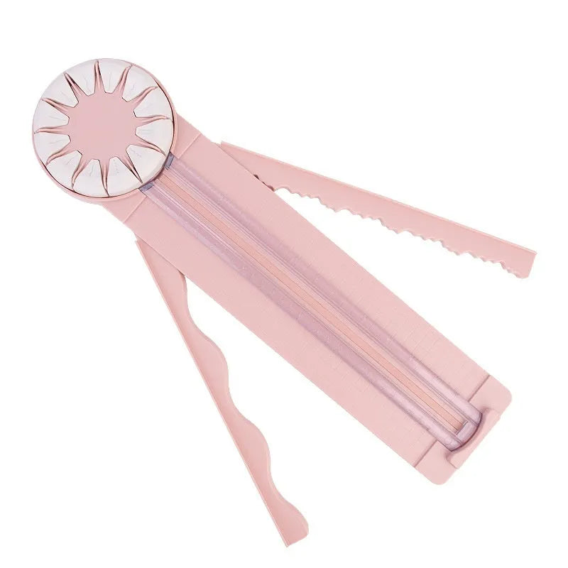 Pink and black 12-in-1 dotted plastic paper cutting machine on a white background.