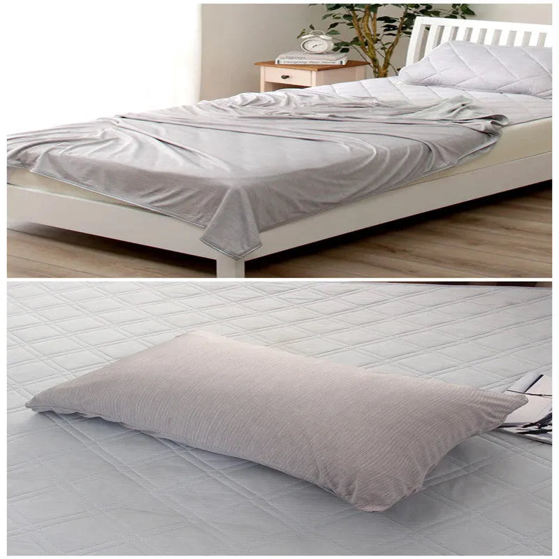 Blue cooling blanket with Q-Max 0.4 cooling fibers, polyester fabric, folded on a bed