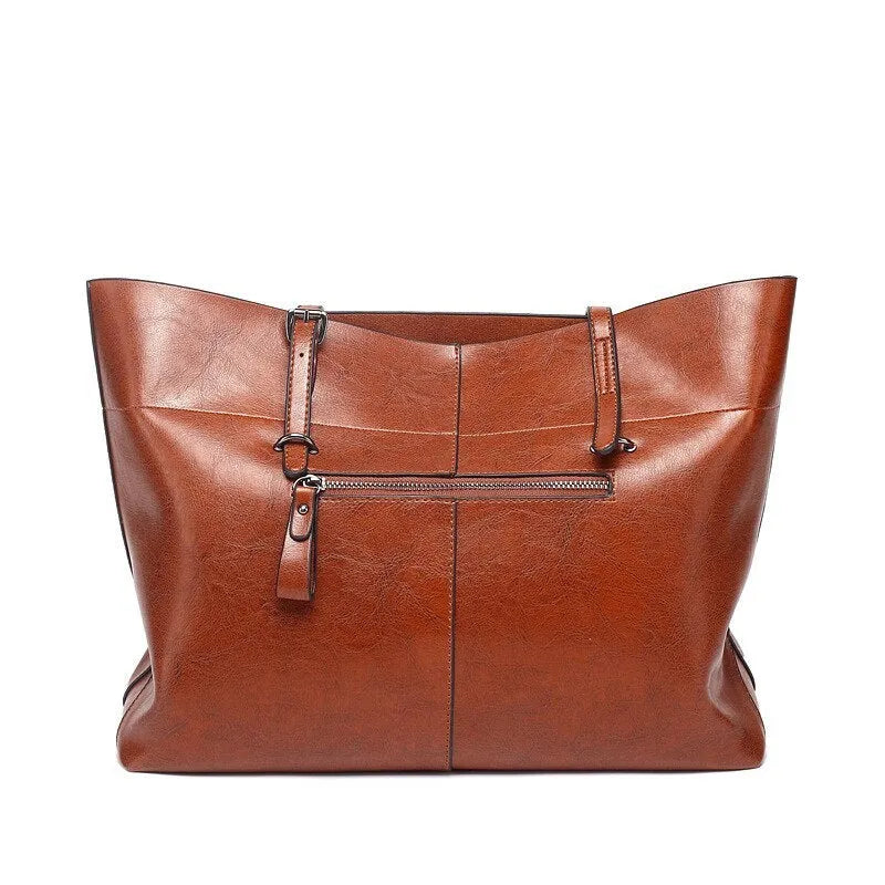 Brown waxed cowhide leather crossbody handbag shown horizontally, displaying two main compartments and a front phone pocket.