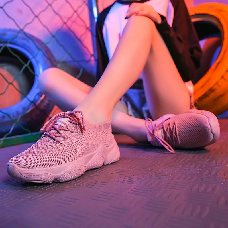 Women's white thick-soled casual sports shoes with flying woven upper and front strap.