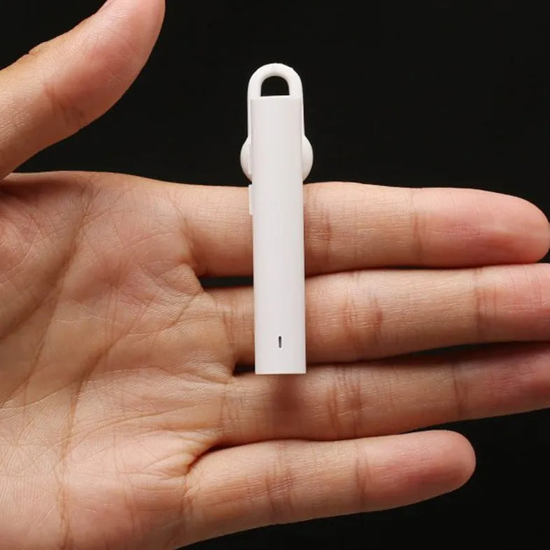 Compact wireless Bluetooth headset in black, measuring 5.6 cm x 1 cm x 0.8 cm, with earpiece and charging port visible