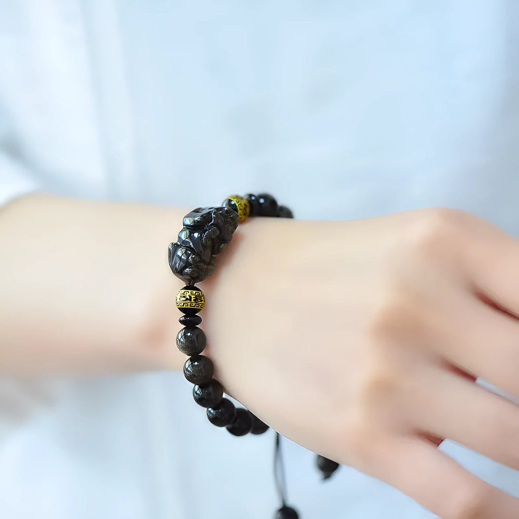 Natural obsidian Pi Xiu bracelet with hand-woven cord and golden sheen on black beads