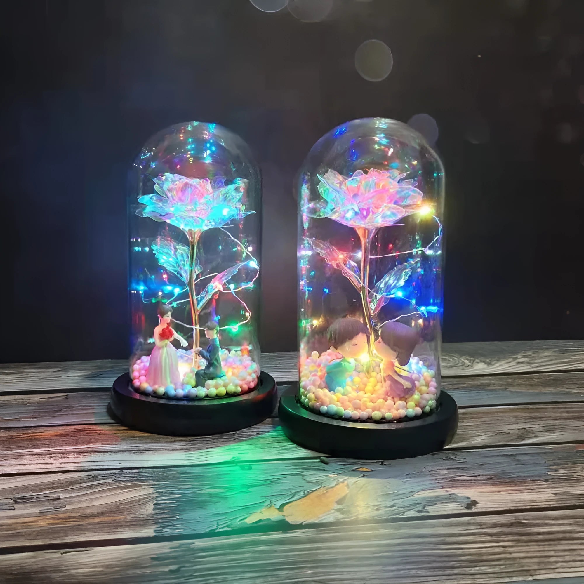Artificial gold rose in glass flask with LED lights on black base, 20cm tall
