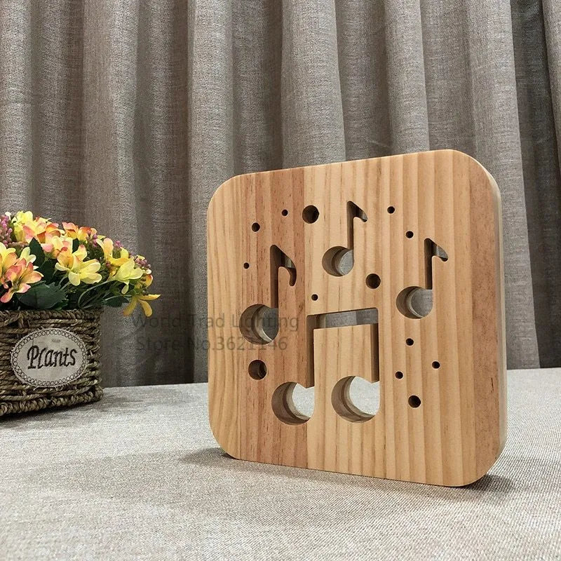 Pine wood cube LED atmosphere lamp with warm white light, showing USB cable and button switch.