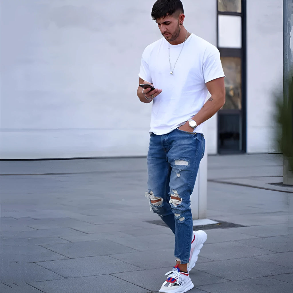 Men's deep blue cotton jeans with hole detailing showing front and back views