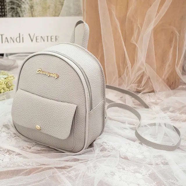 Black PU leather small women's backpack with zipper, shown as a shoulder bag