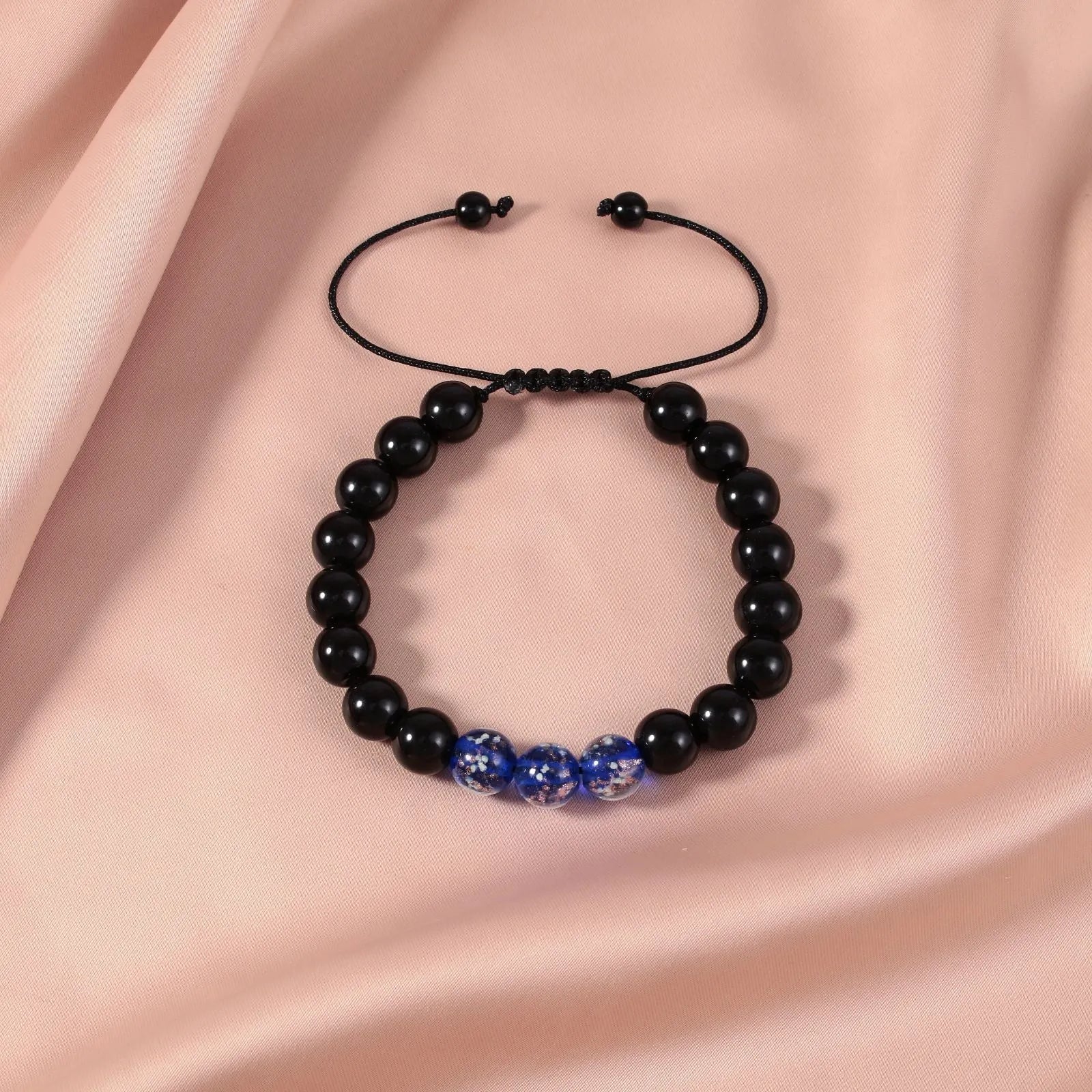 Beaded adjustable luminous bracelet in six colours: black, red, green, pink, blue, sapphire blue, glass or coloured glaze beads, geometric shape