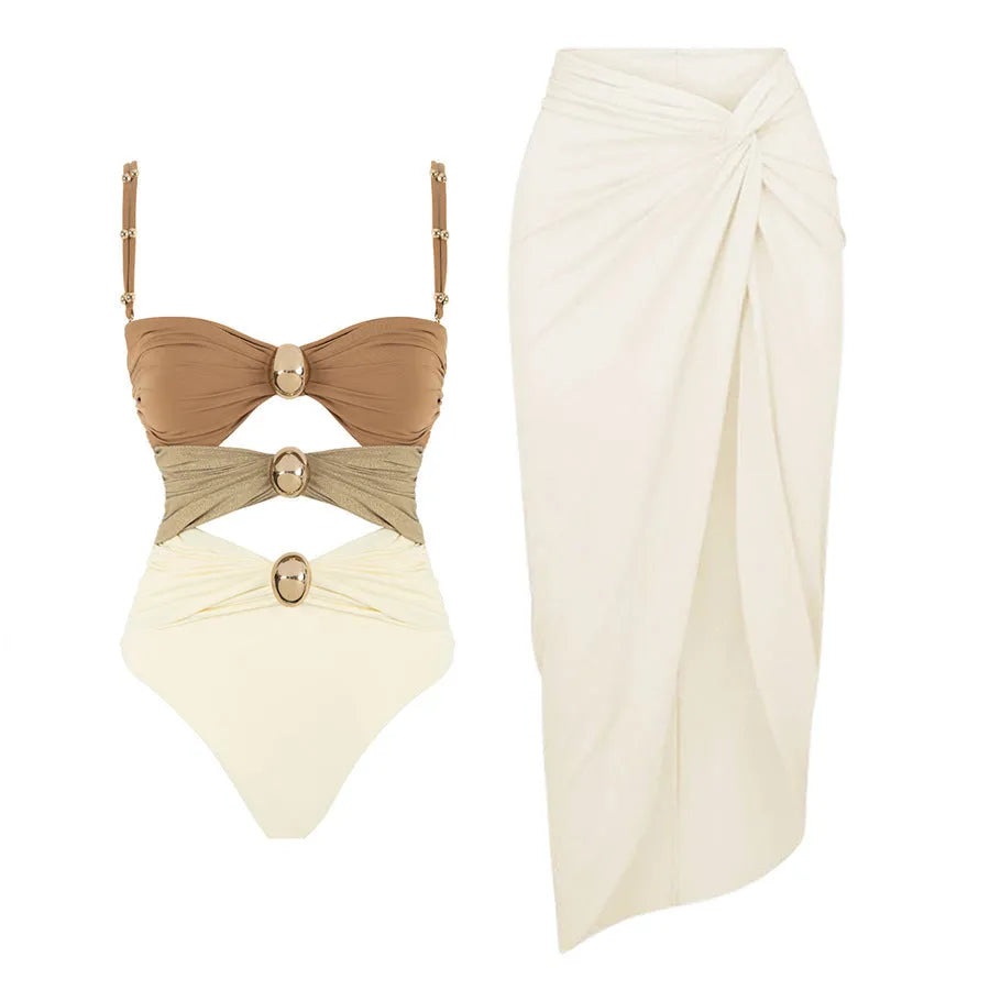 Women's one-piece swimsuit with attached skirt featuring gold button detail in solid colour design