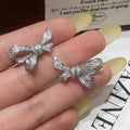Gold electroplated copper bowknot earring with miniature zircon inlay on silver needle post