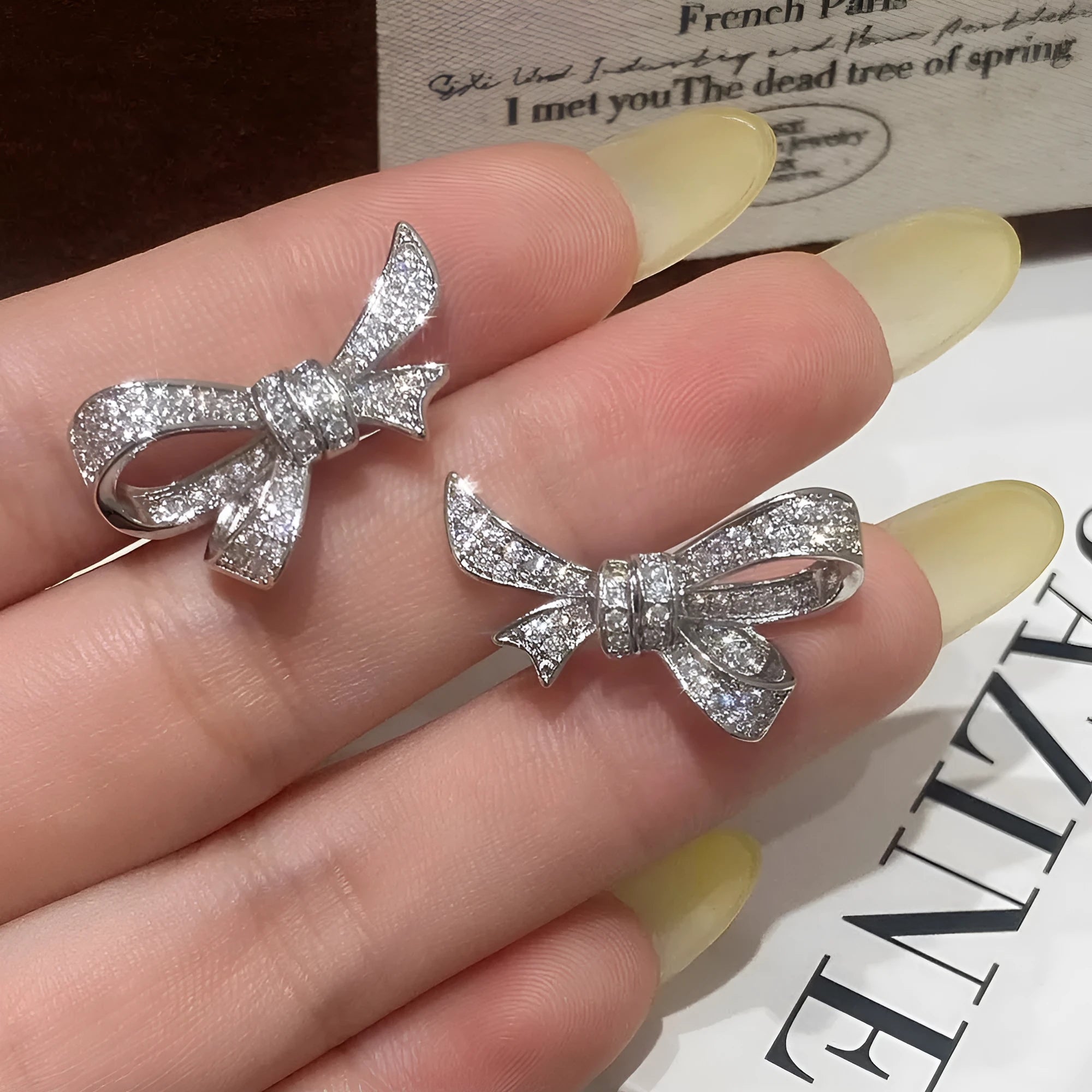 Gold electroplated copper bowknot earring with miniature zircon inlay on silver needle post