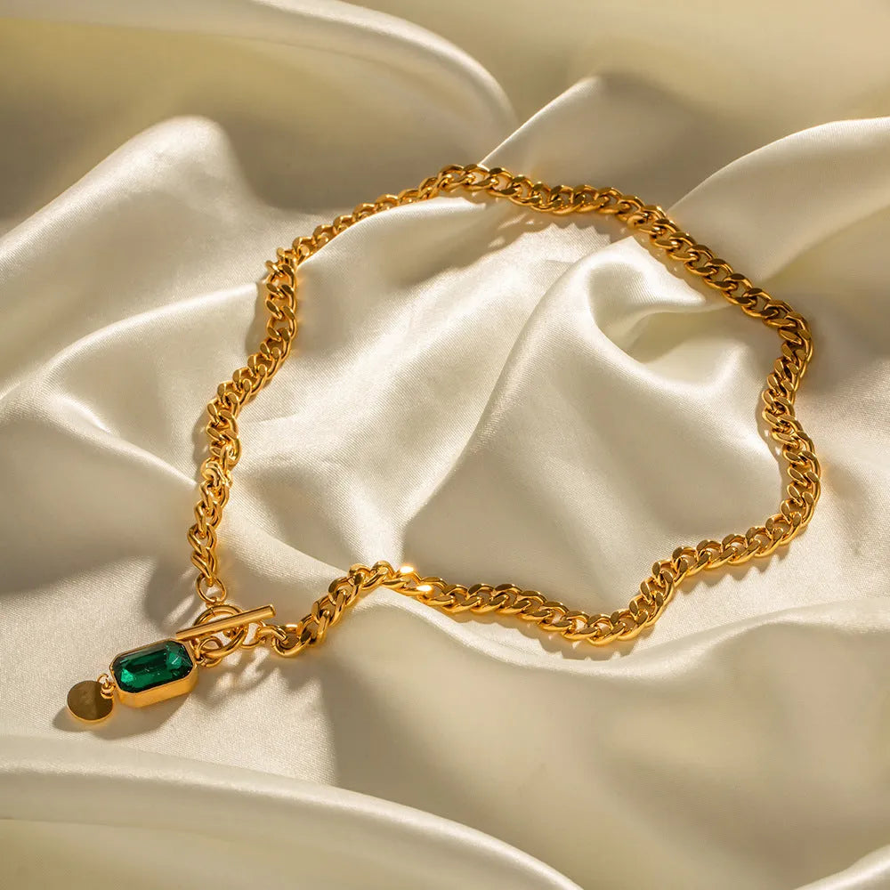 Gold electroplated titanium steel necklace with geometric round emerald zircon pendant on Cuban chain