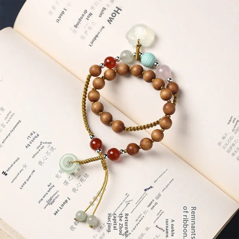 Women's ebony hand-woven double ring bracelet with Ruyi motif, available in Xiuyan jade colour